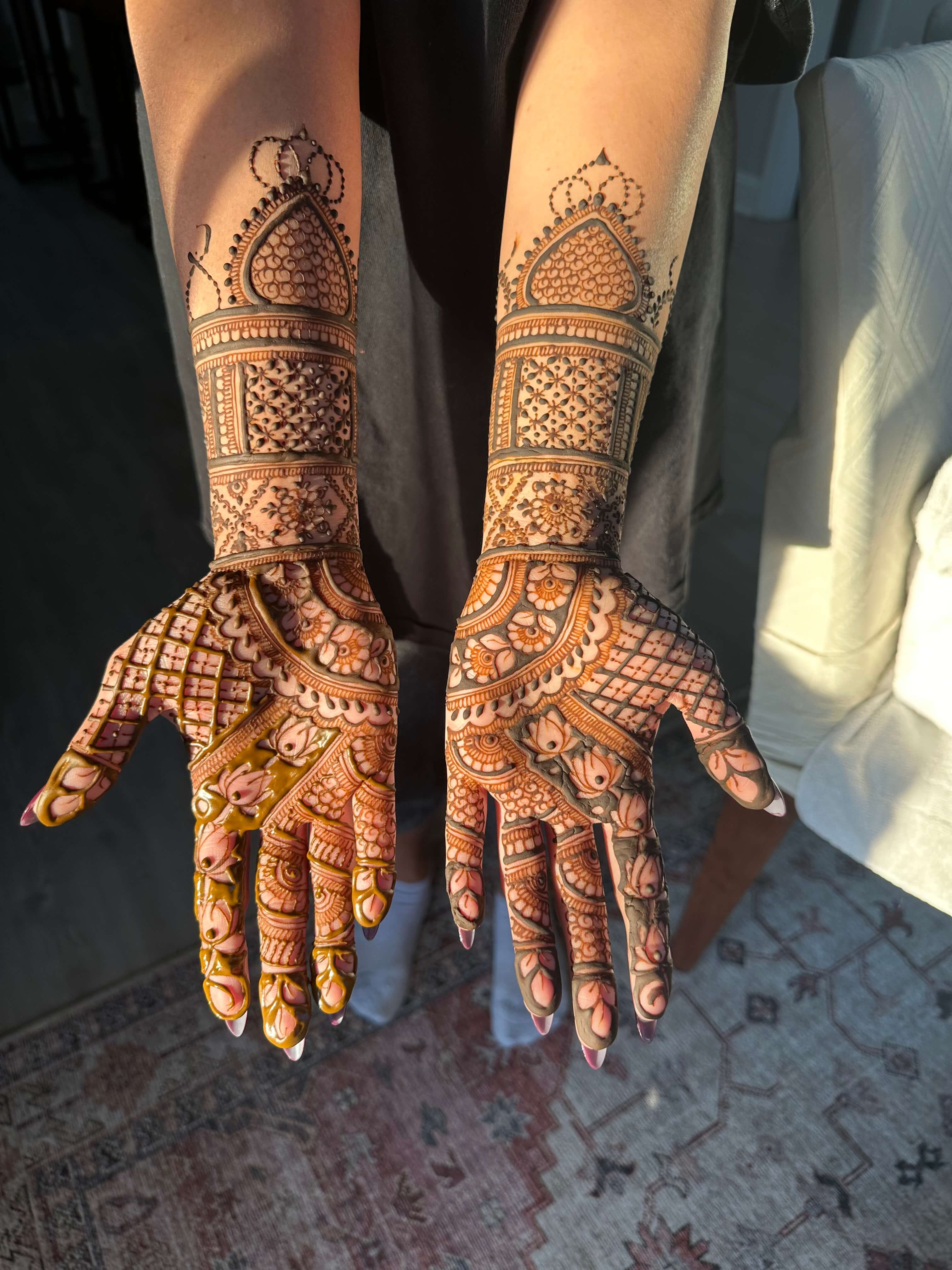 Intricate bridal mehndi design covering full arm with traditional Indian floral and paisley patterns by Hiral's Henna, professional bridal henna artist in Atlanta, Georgia