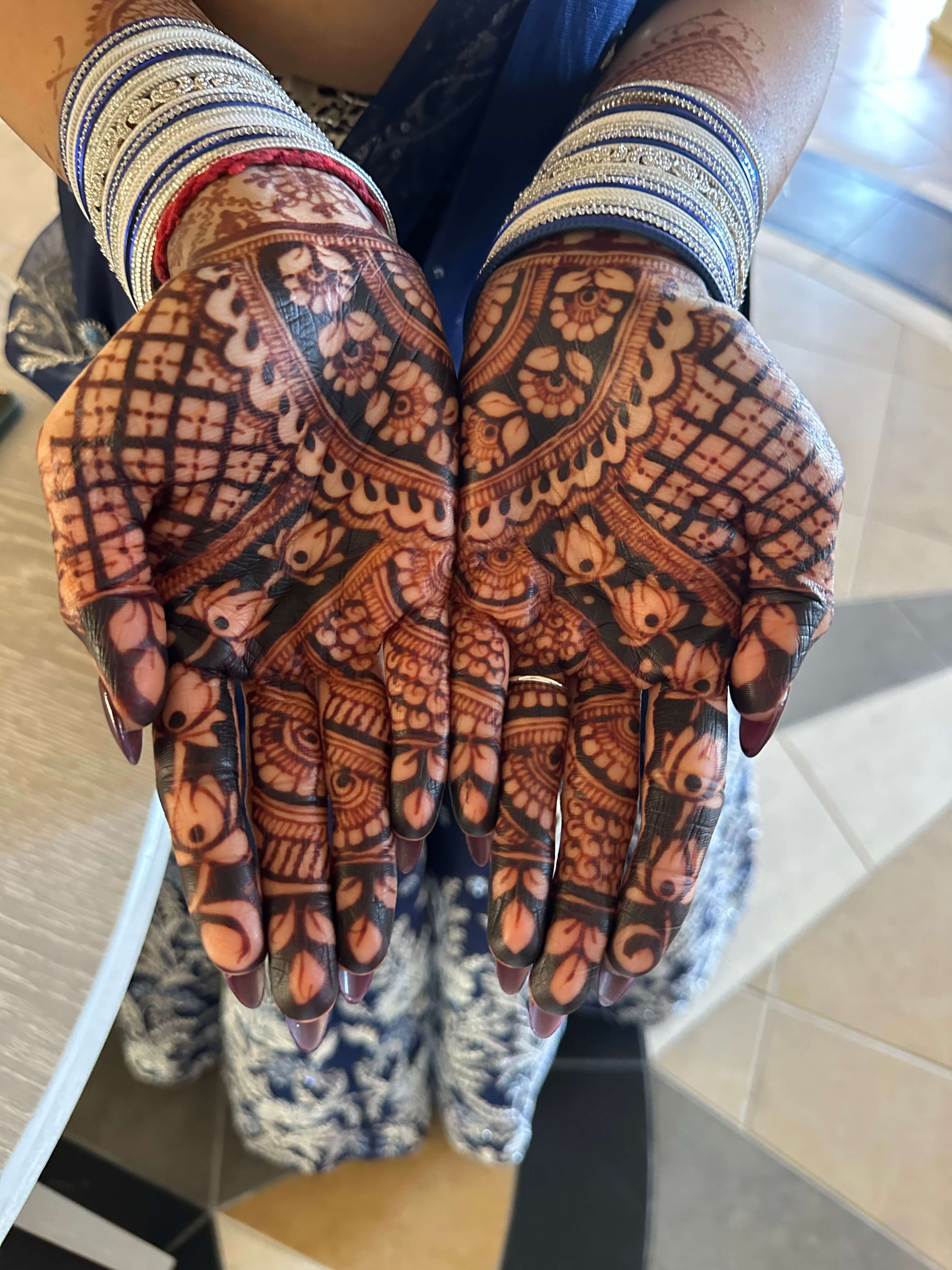 Engagement henna with rich deep stain on hands showcasing detailed mehndi artistry by Hiral's Henna in Atlanta, Georgia
