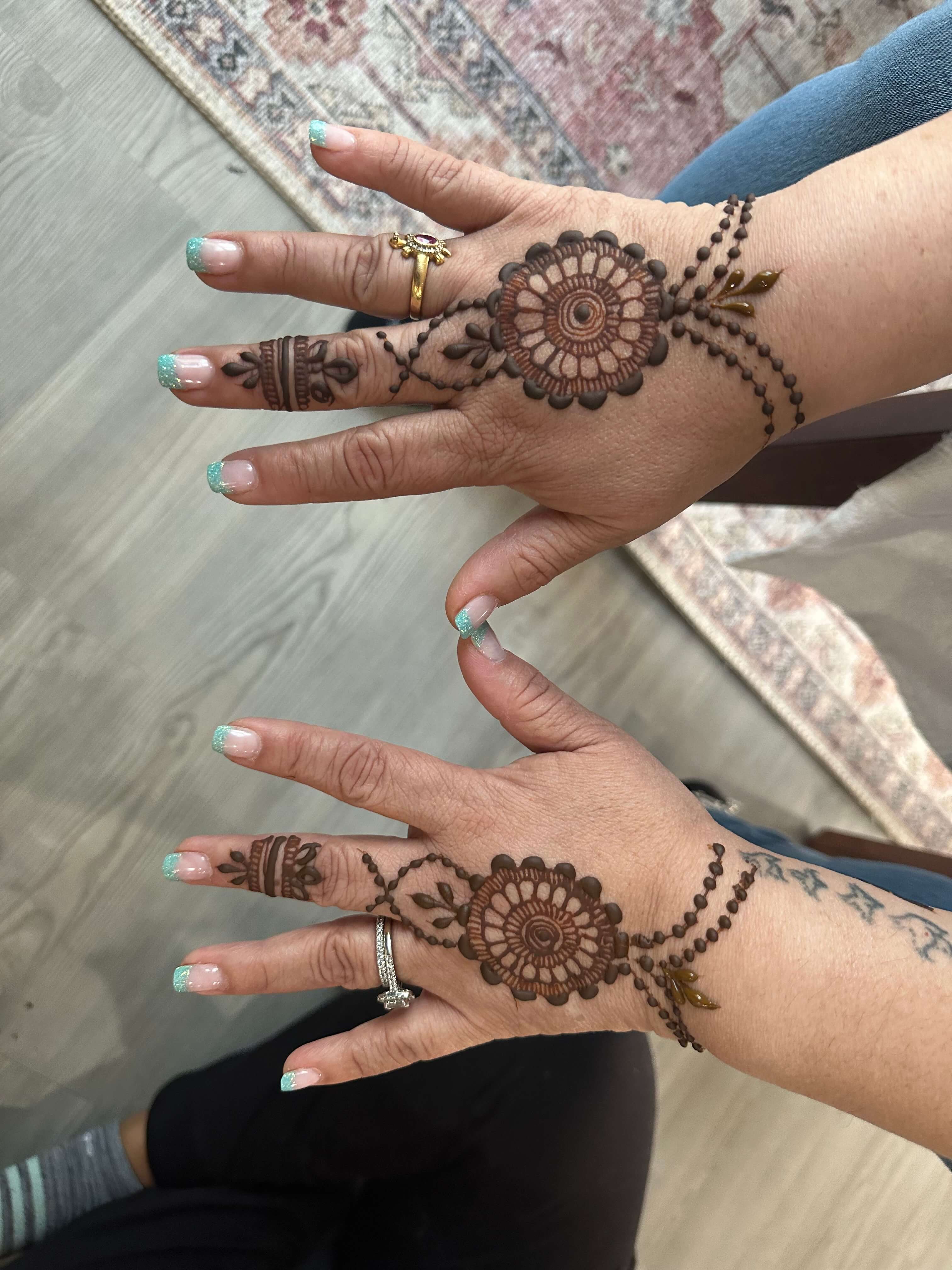 Small elegant henna designs at a corporate event in Atlanta by Hiral's Henna, professional mehndi entertainment for team-building and company parties in Georgia